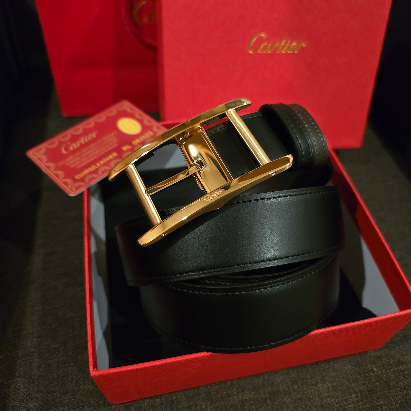 Cartier cinturón Tank reversible negro y café hebilla dorada
